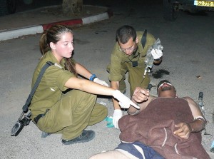 IDF soldiers treating a Palestinian man. Photo: wiki commons.
