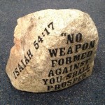 The rock thrown through the windows of Victory Assembly of God Church in Sharon, Mass., last month has been repurposed as a symbol of hope, inscribed with the words of Isaiah 54:17, “No weapon forged against you shall prosper.” Photo: Victory Assembly of God Church.