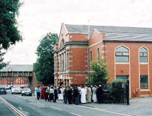 Muslim men standing outside an Islamic centre in Little Harwood, United Kingdom. Photo: Wikipedia.