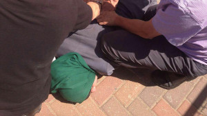 The Arab woman who stabbed an Israeli in Rosh HaAyan being subdued. Photo: Screenshot.