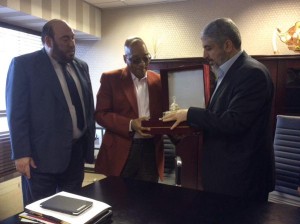 South African President Jacob Zuma accepts a gift from Hamas leader Khaled Mashal.