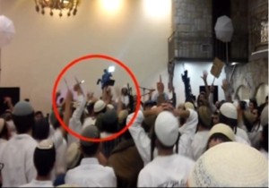 The wedding video shows celebrants dancing while holding the photo of the baby burned alive in the West Bank. One of them is stabbing the photo of the infant with a knife. Photo: Screenshot.