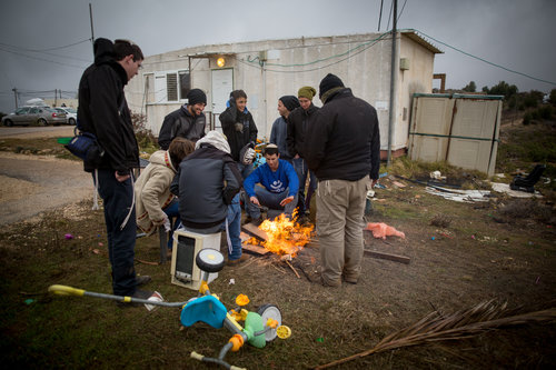 Amona residents cook coffee Dec. 18, 2016. Residents of the 40-home West Bank settlement have agreed to a last-minute government proposal to shift the community to an adjacent plot of land on which the Israeli government will build 52 permanent homes and additional infrastructure. Photo: Miriam Alster/Flash90.