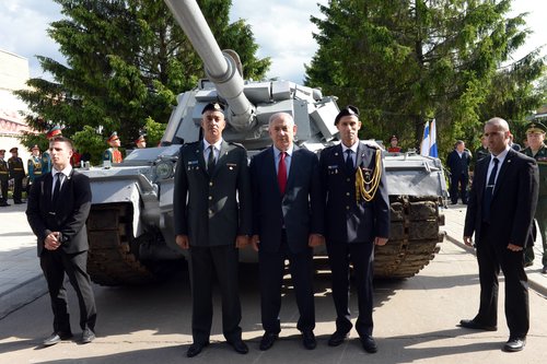 Israeli Prime Minister Benjamin Netanyahu (center) visits an armory museum in the Russian capital of Moscow June 8, 2016. The museum housed an Israeli tank captured by the Syrian army during the First Lebanon War's battle of Sultan Yacoub, but following a request by Netanyahu, Russian President Vladimir Putin agreed to return the tank to Israel. Photo: Haim Zach/GPO.