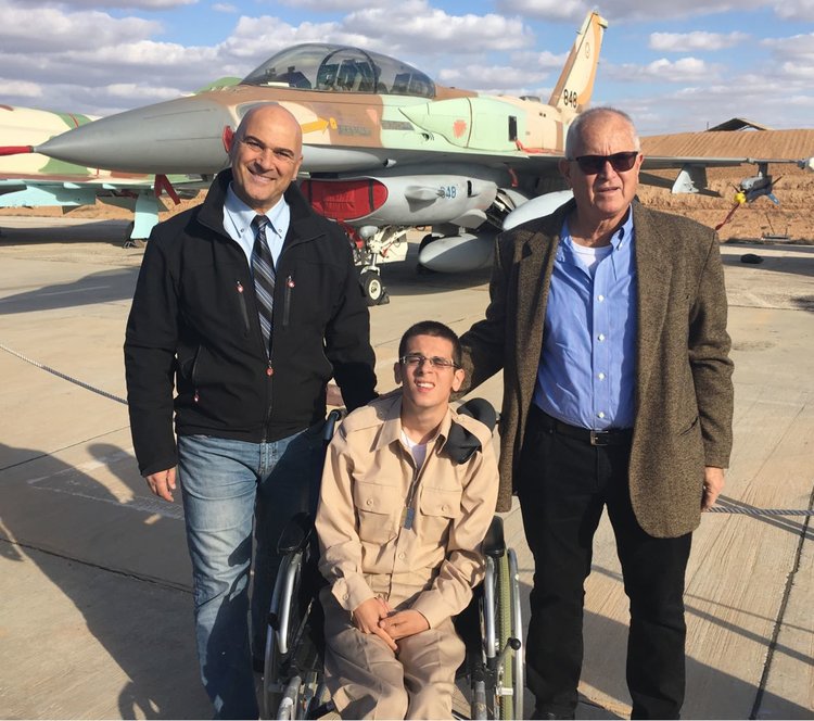 Omer Lahat (center), who has cerebral palsy and recently joined the Israel Defense Forces, is pictured at a Dec. 29 graduation ceremony for an Israeli Air Force pilots' course. Photo: Special in Uniform.